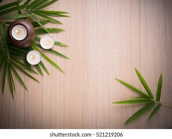 Spa still life concept,Close up of spa theme on wood background with burning candle and bamboo leaf