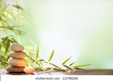 Spa still life with stacked of stone,burning candle and bamboo leaf - Shutterstock ID 113780260