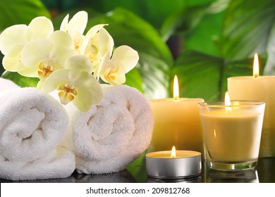 Spa still life with towel and burning candles.