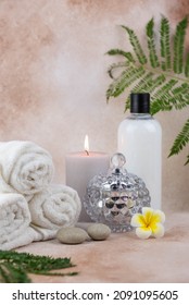 Spa still life treatment composition on massage table in wellness center. Twisted hot towel with aromatic candles on beige background. Aroma therapy setting. Concept of harmony, balance and meditation - Shutterstock ID 2091095605