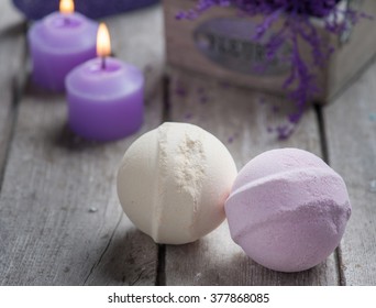 SPA still life,bath bombs closeup with violet flowers on wooden background. 
