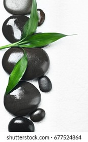 Spa stones with bamboo on white background