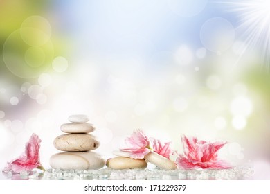 Spa Stones And Pink Flower On Colorful Spring Background 