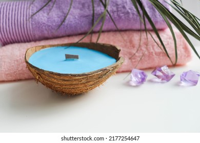 spa theme. set of towels and aroma candle in coconut made from natural soy wax