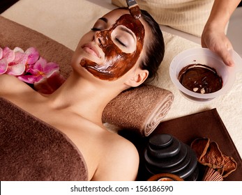 Spa therapy for young woman having  facial mask at beauty salon - indoors