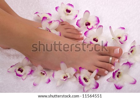 Spa treatment with beautiful orchids on soft cotton towel