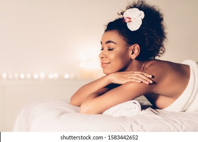 Spa Treatment. Black Woman Relaxing In Spa Salon, Waiting For Masseur, Empty Space