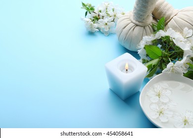 Spa Treatment With Blooming Branch On Blue Background