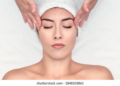 Spa treatment. Facial massage. Massage of the client's forehead. - Shutterstock ID 1848103861