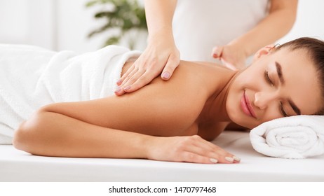 Spa Treatment. Masseur Doing Shoulder Massage On Woman Body, Closeup