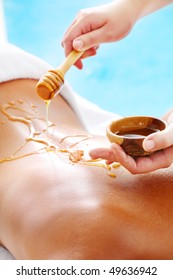 Spa Treatment - woman undergoing  spa treatment with honey.