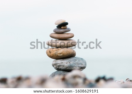 Spa and wellness background. Stack of pebble stones on the beach.