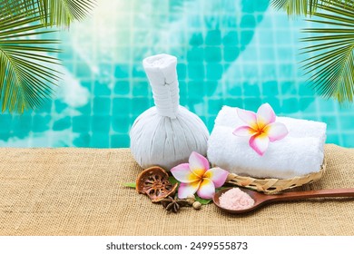 Spa and wellness concept background, herbal massage ball with pink salt over blurred swimming pool background - Powered by Shutterstock