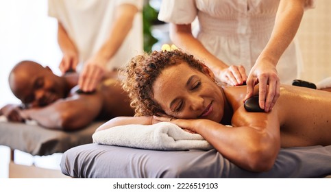 Spa, wellness and massage for couple and hot stone therapy, massage therapist hands for stress relief and body health. Man and woman relax with luxury service at beauty salon, peace and detox release - Powered by Shutterstock