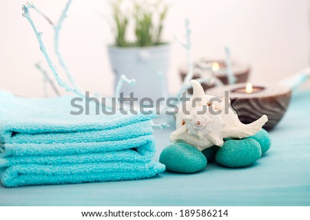 Spa and wellness setting with flowers, candles and towel. Blue dayspa nature set with copyspace