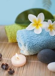 Spa And Wellness Setting With Flowers, Stones, Candles And Towel In Blue Tone