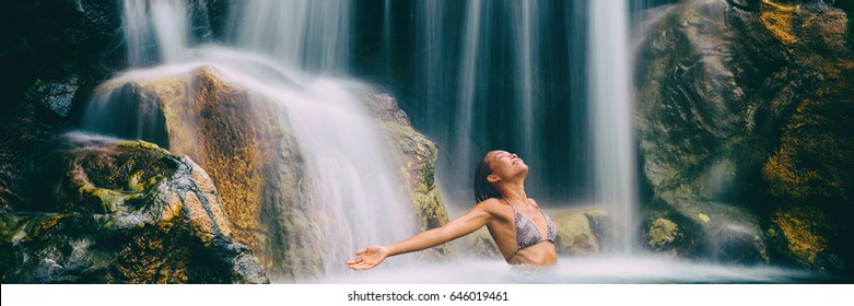 Spa and wellness waterfall woman carefree banner. Happiness woman relaxing in water with arms up raised in freedom. Health and relaxation. Waterfall bikini girl landscape panorama crop. - Powered by Shutterstock