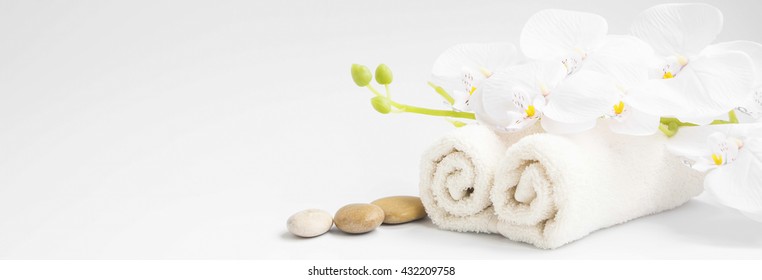 Spa white orchid flower with white cotton towels setting