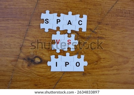 SPAC Versus IPO Concept Displayed Using Puzzle Pieces on Wooden Background