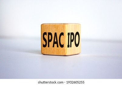 SPAC vs IPO symbol. Wooden cube with words 'SPAC, special purpose acquisition company' and 'IPO, initial public offering' on beautiful white background, copy space. Business and SPAC vs IPO concept.