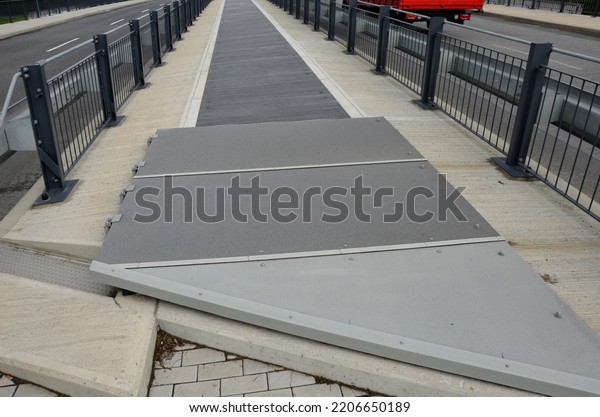 the space\
between the lanes of the highway bridge is blocked by a grid. the\
guardrails are in combination with the black metal railing bolted\
to the concrete bridge, tension\
rod