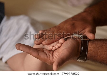 In the space between two cupped palms, an entire universe of new responsibility quietly begins.
A father's strong, sun-weathered grip, wearing a leather watch strap that marks the passage of ordinary time, cradles the tiny, perfect foot of his newborn daughter with extraordinary tenderness. The contrast tells the whole story without a single word: large, weathered and capable on one side, impossibly small, soft and entirely dependent on the other. Soft natural light wraps around the scene, drawing every eye toward that single, delicate point of contact where fatherhood becomes physically, undeniably real.
This is one of the quietest and most profound moments in the entire human experience, the instant a man fully absorbs that someone new now relies on him completely. No dramatic gesture, no grand declaration, just a careful, instinctive hold that no one ever has to teach.
Parenthood rarely announces itself with fanfare. More often it arrives exactly like this: in stillness, in touch, in the simple act of holding something precious as if your entire life now revolves around keeping it safe. For every father who has experienced that overwhelming first wave of protective love, this image speaks with immediate, universal recognition.
A tiny foot. A steady grip. A lifetime of devotion beginning in complete silence.
