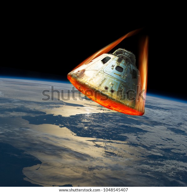 A space capsule reenters the\
earths atmosphere causing the heat shield to glow from the friction\
of tremendous speed. Elements of this image courtesy of\
NASA.