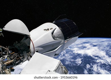 The Space Crew Dragon spacecraft is docked to the International Space Station. Elements of this image furnished by NASA. - Powered by Shutterstock