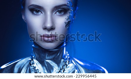 Space girl in a silver suit with a vanguard make-up