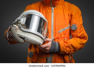 Space Helmet In The Astronaut Hands Close Up. Cosmic Tourism Concept.