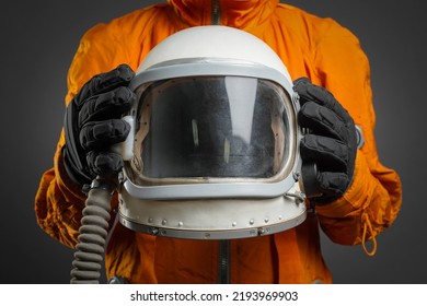 Space Helmet In The Astronaut Hands Close Up. Cosmic Tourism Concept.