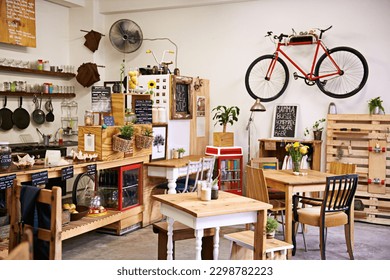 Space, interior and empty coffee shop with table, chairs and furniture or small business, bistro and cafe with unique design and style. Background, creative startup and food store with bike on wall - Powered by Shutterstock