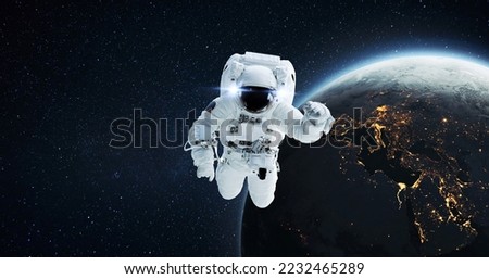 Space man astronaut flying in outer space with amazing night planet earth with city lights. Successful start of space mission and space exploration