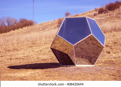 Space Mirror Polyhedron On Red Planet On Blue Sky Background. Unusual Surrounded By Usual. Modern Concept Art Installation On Nature. Reflection Of Habitual In Versatile Object. Beautiful Futuristic