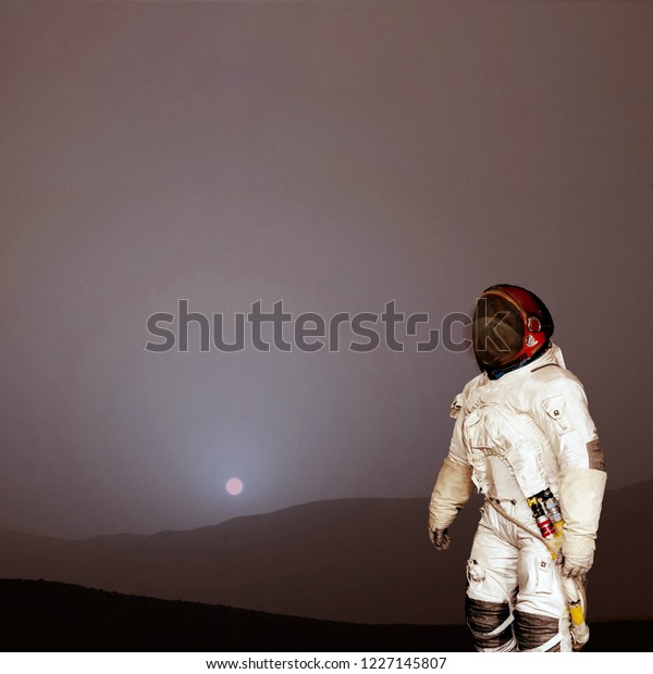Space mission. Astronaut and rocky\
landscape. The elements of this image furnished by\
NASA.\
