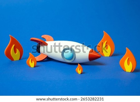 Space rocket crashed and on fire. Business failure, failed startup. Downfall of ambitious plans, flawed execution, or crisis outcomes. Volatility of startups, financial risks, or unexpected setbacks.