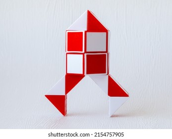 space rocketred and white bicolor magic snake Transformable twist puzzle in shape of space rocket isolated on white background. it develops spatial thinking.