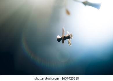 Space Satellite Orbiting The Blue Planet. Decorations For Photo Sattelite. Selected Focus