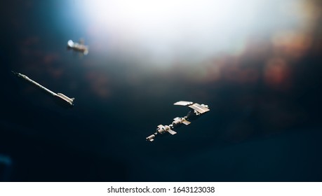 Space Satellite Orbiting The Blue Planet. Decorations For Photo Sattelite. Selected Focus