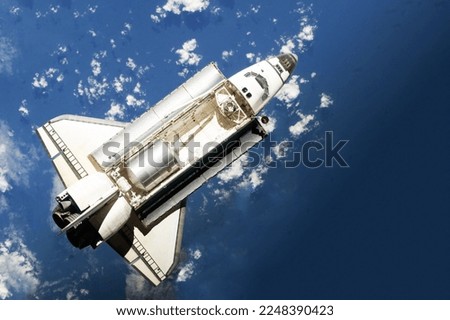 Space shuttle above the surface of the Earth. Elements of this image furnished by NASA. High quality photo