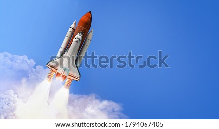 Space shuttle in the blue sky with cloud. Launch of spaceship. Space wallpaper. Elements of this image furnished by NASA