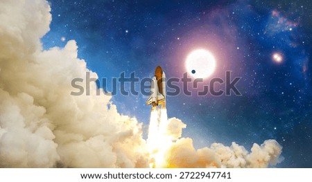 The space shuttle flight from Earth surface into space. The spacecraft in a cloudy night sky. The launch of rocket carrying astronauts into outer space. The anniversary of the space shuttle launch. Landscape of night sky with clouds, stars and spaceship. Elements of this image furnished by NASA