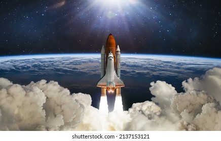 Space shuttle flight in space. Rocket launch. Earth planet and clouds space wallpaper. Elements of this image furnished by NASA - Shutterstock ID 2137153121