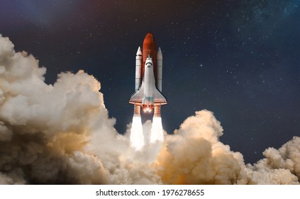 Space shuttle launch in the clouds to outer space. Dark space with stars on background. Sky and clouds. Spaceship flight. Elements of this image furnished by NASA - Powered by Shutterstock
