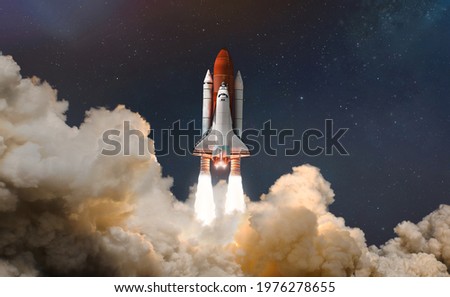Space shuttle launch in the clouds to outer space. Dark space with stars on background. Sky and clouds. Spaceship flight. Elements of this image furnished by NASA