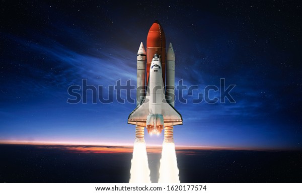 Space shuttle launch in the open space over the\
Earth. Sky and clouds under space ship. Elements of this image\
furnished by NASA