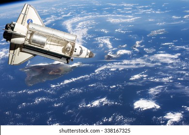 Space Shuttle orbiting the earth. Elements of this image furnished by NASA. - Powered by Shutterstock