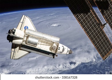 Space Shuttle orbiting the earth. Elements of this image furnished by NASA. - Powered by Shutterstock