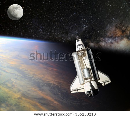 Space Shuttle orbiting the earth. Elements of this image furnished by NASA.