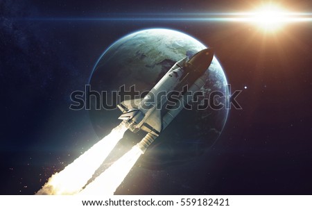 Space shuttle orbiting Earth planet. Elements of this image furnished by NASA